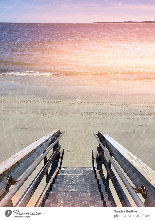 Stairs to the sea Ocean ocean wooden staircase Colour photo Deserted deserted beach Sunlight Warmth Exterior shot coast coastline Water Nature Tourism Sand