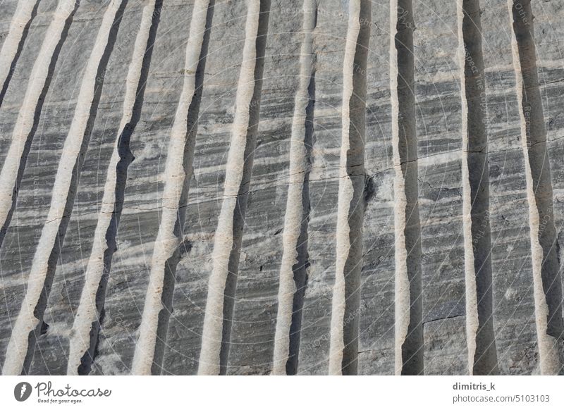 unprocessed marble background with extraction cuts lines texture stone rock mineral metamorphic closeup abstract natural grungy cracked gray detail macro