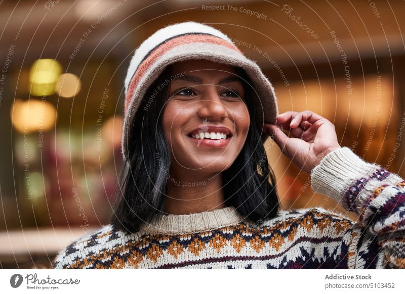 Stylish black woman on street style smile happy appearance outfit portrait hat sweater female young ethnic knitwear glad casual optimist personality