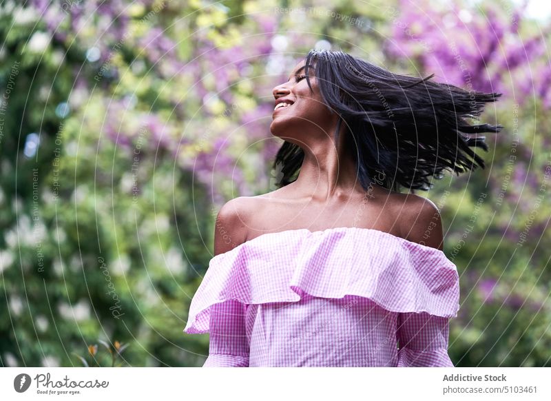 black woman amidst blooming branches tree flower lush park spring tender weekend female young ethnic romantic summer calm brunette sensual blossom daytime