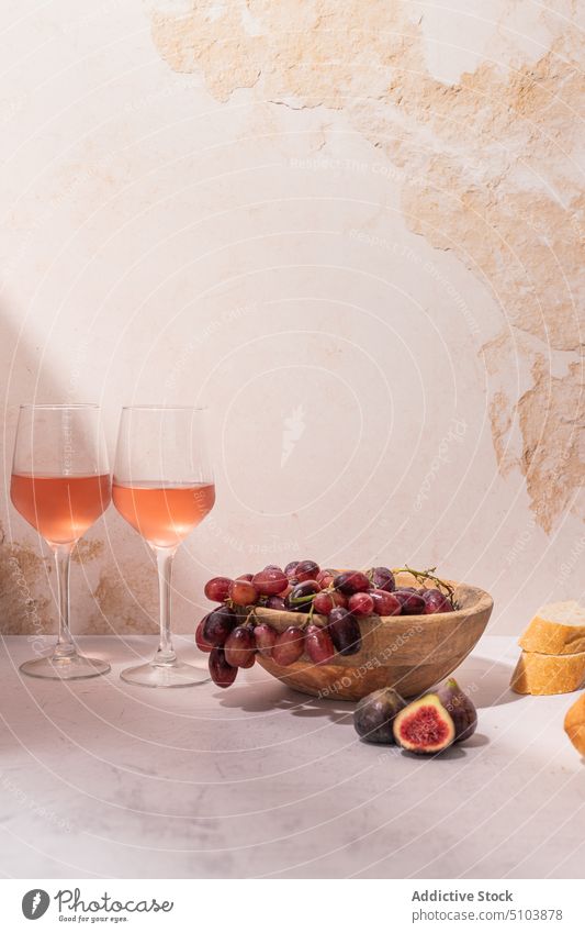 Glasses of wine with fruits on table glass drink bowl grape fig baguette serve food slice red beverage tasty vitamin delicious fresh ripe nutrition organic