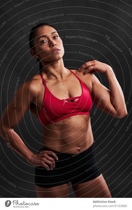 Muscular woman with hands on waist sportswoman hand on waist figure body wellbeing physical studio shot athlete fitness sporty latin hispanic ethnic shape