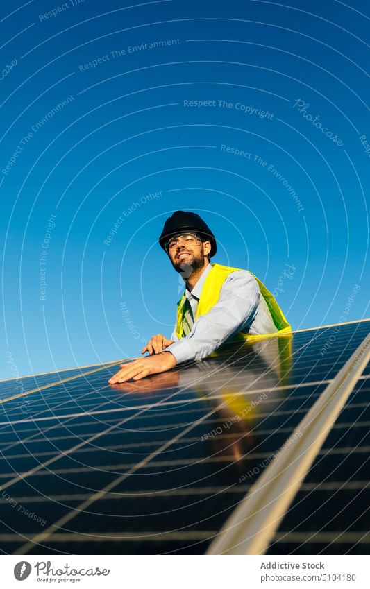 Worker with photovoltaic cells on sunny day man solar panel technician renewal sustainable alternative eco friendly energy male battery installation worker