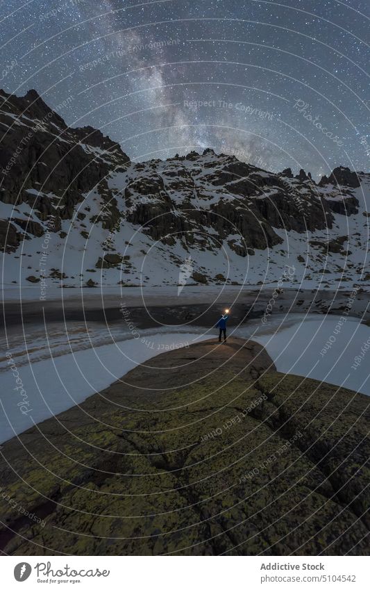 Anonymous traveler contemplating mountains and pond under Milky Way man milky way nature highland landscape astronomy night admire contemplate torch