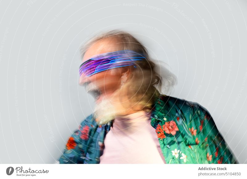 Laughing aged man in trendy glasses appearance sunglasses retrowave rave party 80s having fun personality individuality style studio male charismatic creative