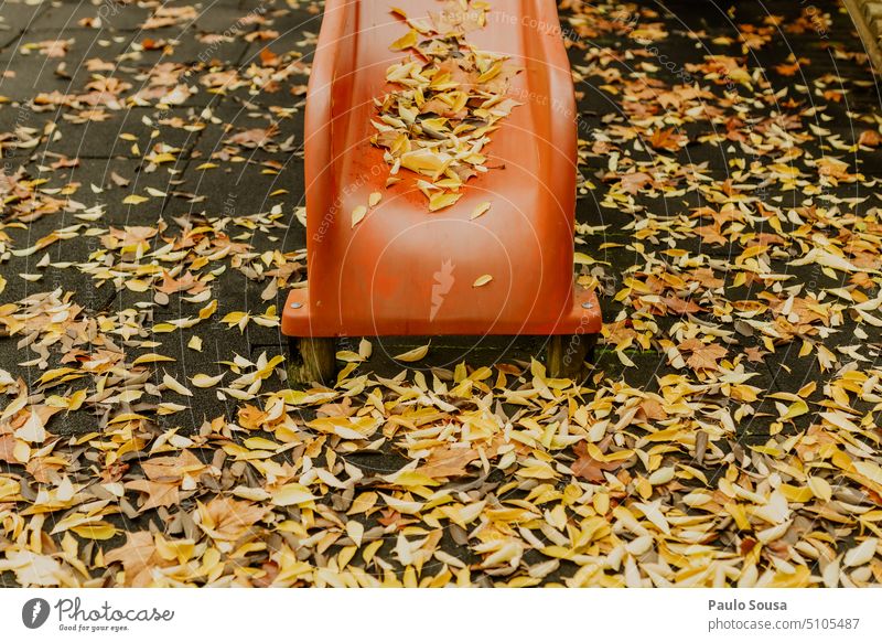 Red slide with yellow leaves Yellow Autumn Autumn leaves fall autumn mood foliage Autumnal colours Early fall autumn leaves leaf nature Park Playground