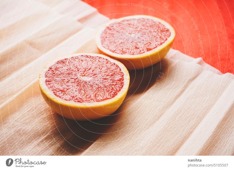 Colorful background in coral and red with fresh open grapefruit texture paper orange peach color juicy new citric healthy temptation vegan vibrant colorful