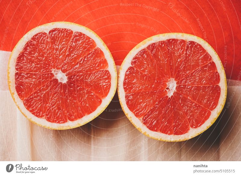 Colorful background in coral and red with fresh open grapefruit texture paper orange peach color juicy new citric healthy temptation vegan vibrant colorful