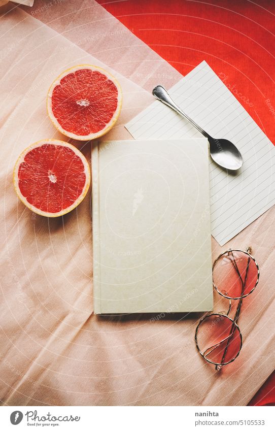 Flat lay background image with a elegant diary surrounded by common objects in vibrant colors flat lay mockup customice warm peach red design elegance