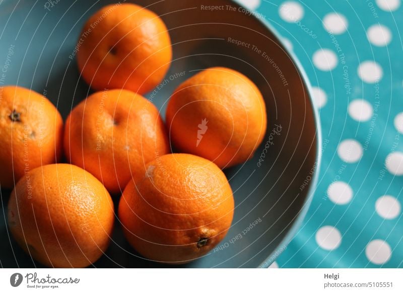 Vitamins - clementines lie in a petrol colored bowl standing on a turquoise tablecloth with white dots mandarins Clementines fruit citrus fruit Fruit vitamins