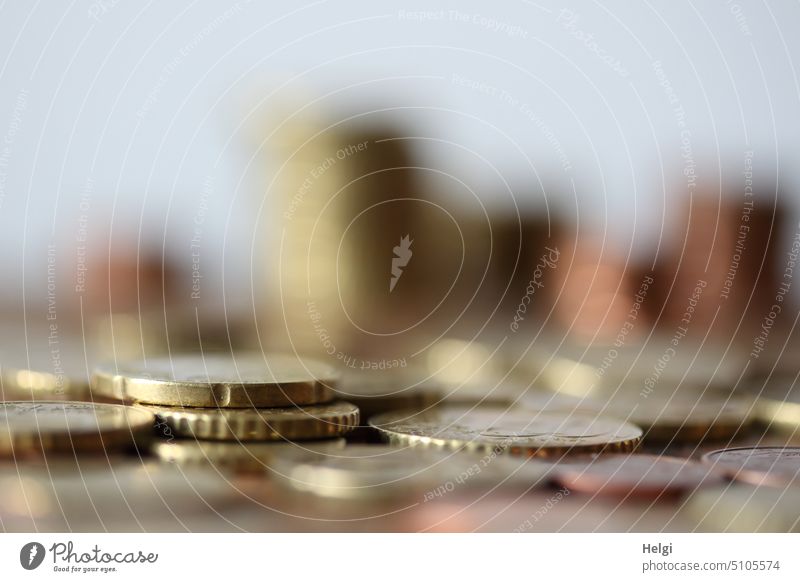 many coins lie on a table, in the background blurred stacked coins Money Euro Coins euro coins euro cents small change Save Paying Many Thriftiness Loose change