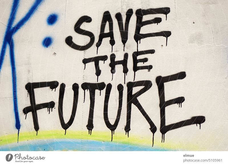 SAVE THE FUTURE is written in black, running block letters on the graffiti wall / fear of the future save the future Fear of the future secure the future Future