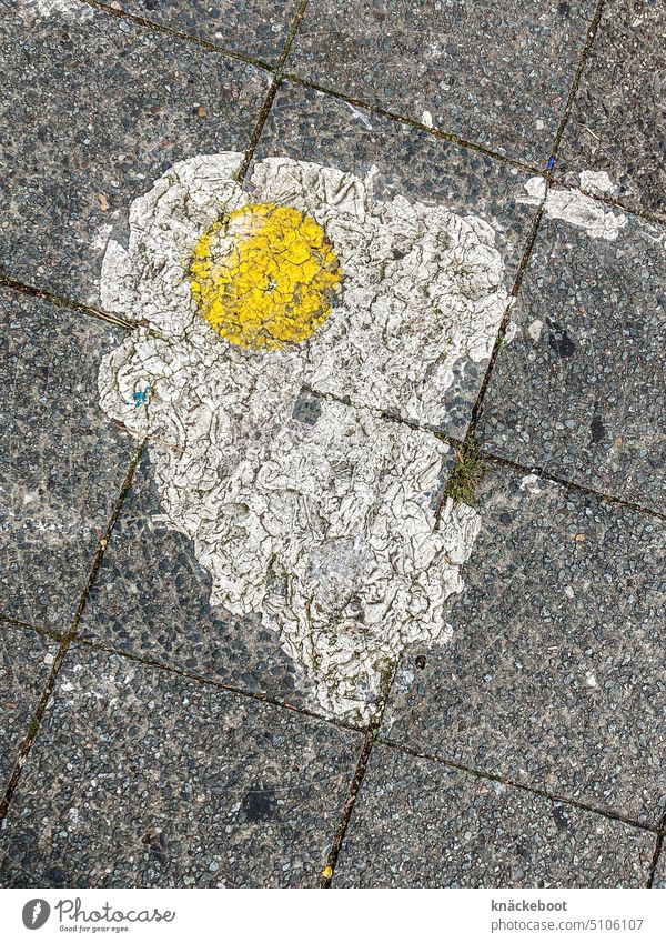 mirror lead on sidewalk Town walkway slabs off Sidewalk Gray splotch of paint Egg Street art photos Yellow White