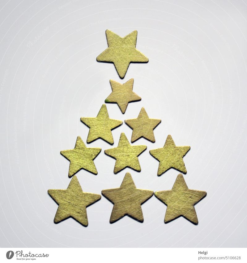 gold colored wooden stars in the shape of fir tree on white background Star (Symbol) Christmas Advent Decoration Wood Gold symbol Christmas decoration