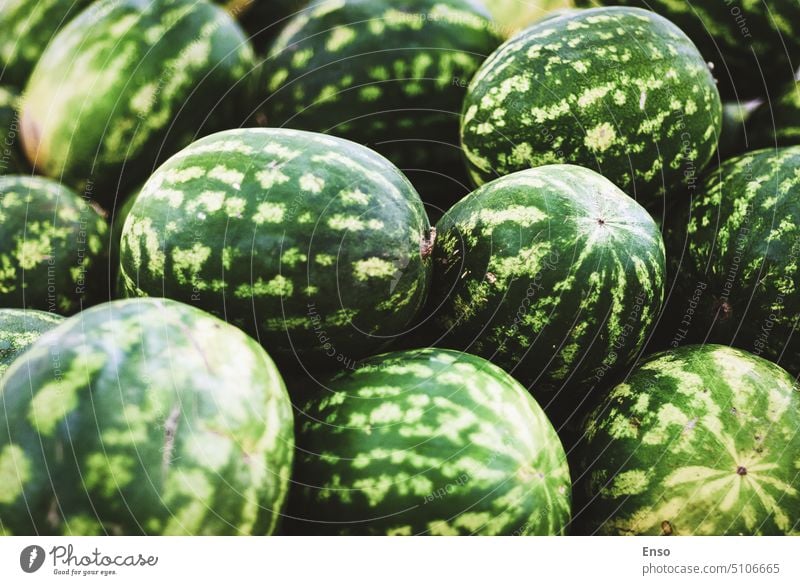 pile of watermelons in grocery store supermarket sale green striped many shop retail fresh fruit sell hypermarket colorful marketplace background aisle choice