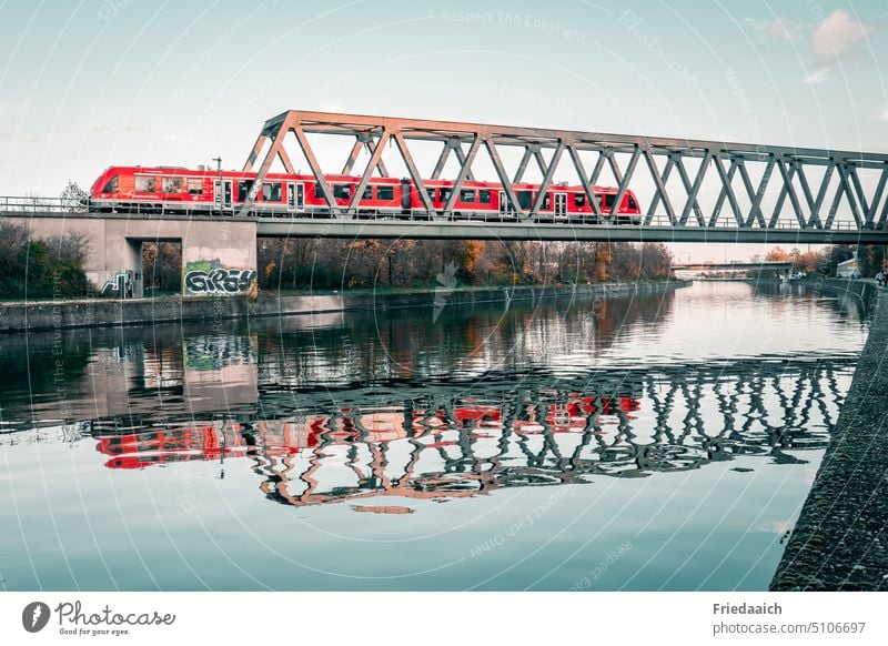 Reflection of a railroad bridge with express train on a canal River Channel reflection Railroad bridge Train Water Train services Bridge railway line