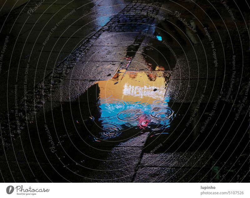Neon sign reflected in puddle Puddle Rain at night Town November Orange Blue Shadow detail water circles people Reflections
