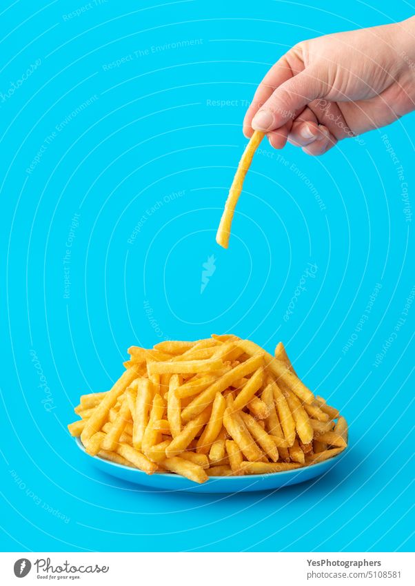French fries plate isolated on a blue background. abundance bright calories close-up color concept copy space crispy cuisine cut out deep-fried delicious design