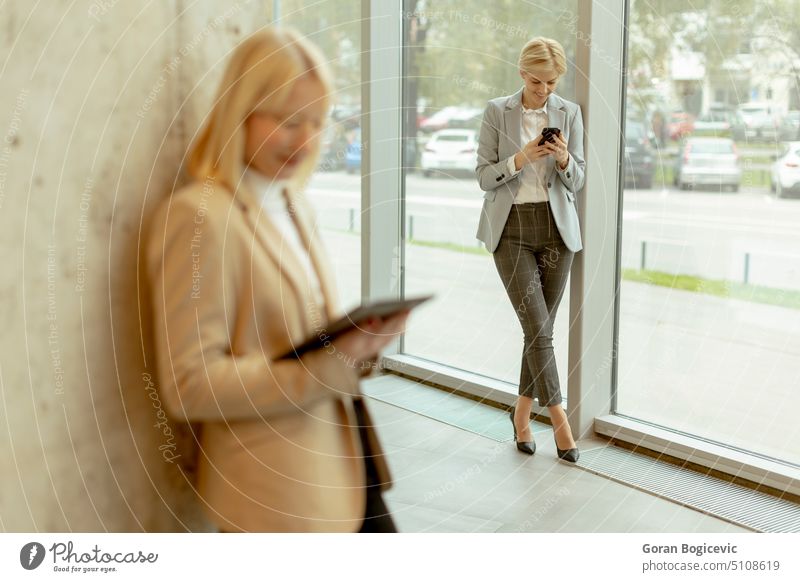 Business women standing in the office corridor adult attractive beautiful beauty bright business business person businesspeople businessperson businesswoman
