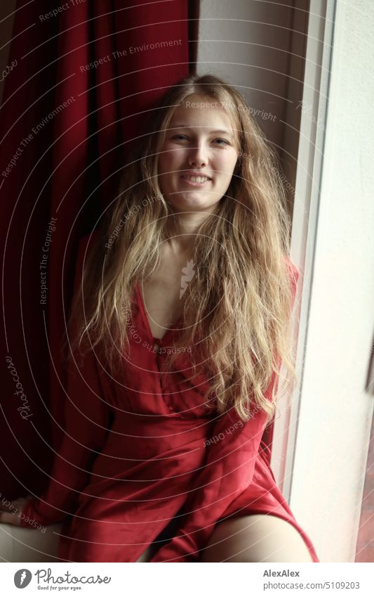 Close portrait of young blonde woman smiling in red dress sitting at window Woman Young woman Blonde Long-haired Smiling Joy Window Slim kind Pleasant pretty