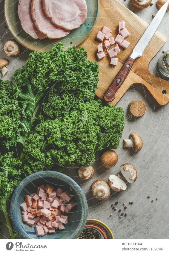 Raw kale with ham and mushrooms on kitchen table, cooking preparation top view. Kale Ham Kitchen Table Cooking Preparation plan Eating boil