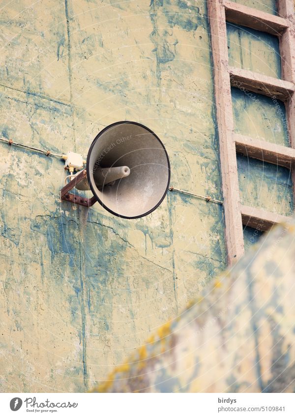 Old loudspeaker on a weathered outdoor wall Loudspeaker Inform alert announcement Information pressure chamber loudspeaker Cor anglais Electric Megaphone