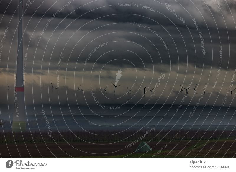 Cloud power energy windmills Clouds Dramatic art Wind energy plant wind power Energy industry Renewable energy Exterior shot dramatic sky Sustainability