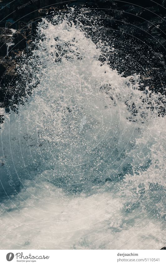 With full force, the ocean currents crash against the rocks, causing the waves to splash high. Sea water Swell Water Waves Exterior shot Surface of water