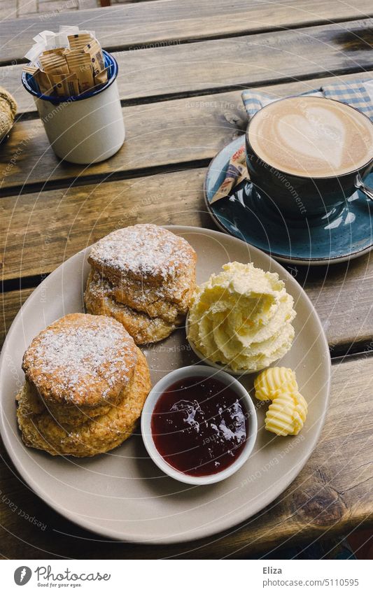 Scones with clotted cream, jam and cappuccino in café scones Cappuccino Café Jam Coffee Artistic experimental Analog Coffee cup Table biscuits coffee and cake