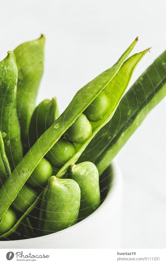 Raw green pea pods on light background organic raw food healthy seed vegetarian fresh agriculture closeup whitw vegetable peas copy space beans healthy food