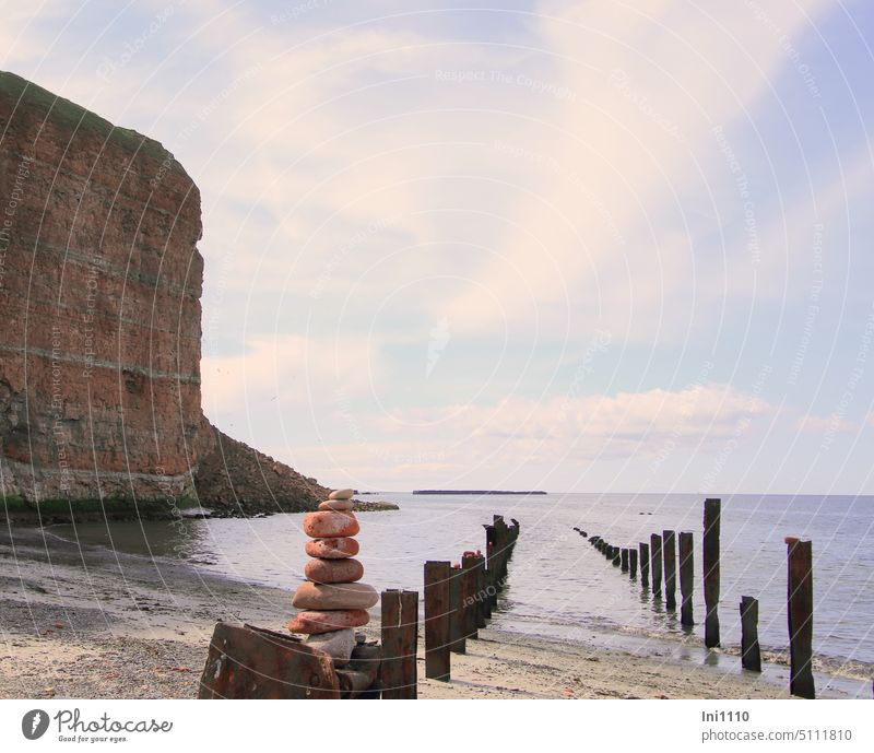 Stone tower on the northeast side of Helgoland North Sea North side Beach Pebble beach Red rock Rock quarry cliff edge Water Ocean Sky wooden posts Steel piles