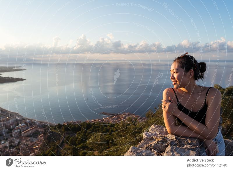 Asian traveler admiring coastal city woman admire smile viewpoint sea sunset weekend cefalu italy sicily female young asian ethnic touch shoulde border lean
