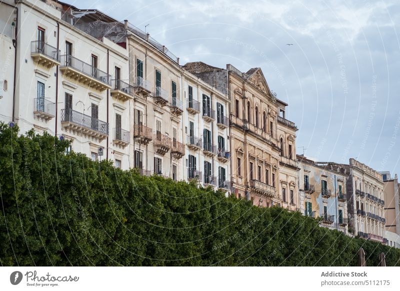 Facade of old buildings in city exterior facade residential window hedge wall trip travel journey aged town heritage weathered sicily construction sightseeing