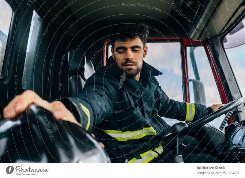 Hispanic fireman preparing to drive fire engine professional driver prepare work emergency uniform protect helmet male adult hispanic ethnic transport auto