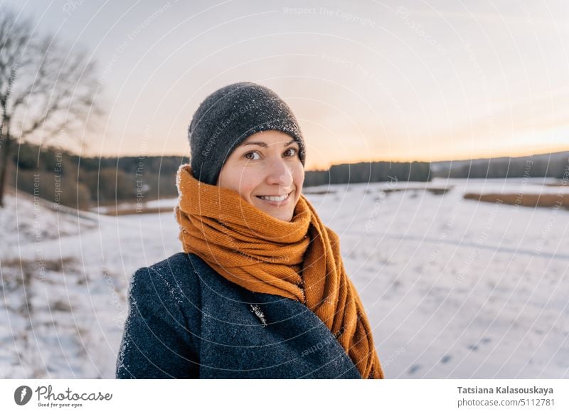 Portrait of a young woman in winter clothes and a hat wrapped in a scarf with a big smile warm clothes female people person European White adult mid adult one