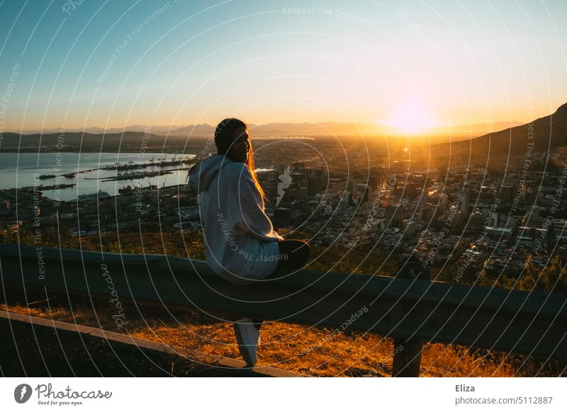 Young woman sitting in hoodie on Signal Hill in Cape Town watching the sunrise Sunrise Woman Dawn South Africa Morning Freedom Adventure travel