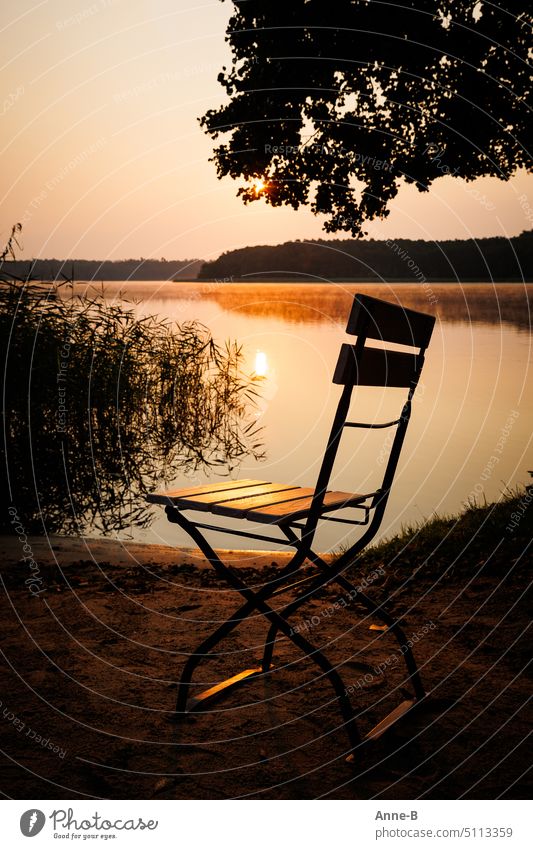 just relax a bit ...lonely garden chair in the evening sun on the lakeshore Sunset Lake Garden chair Restorative relaxation come down evening light pretty