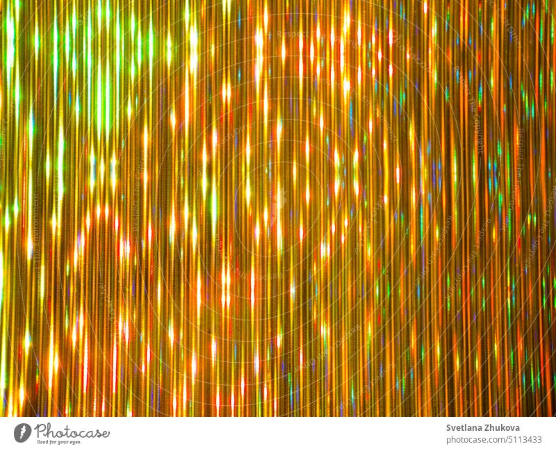 Golden striped luminous background golden metallic abstract blurred yellow brilliant radiant shining colorful vivid vibrant bright light