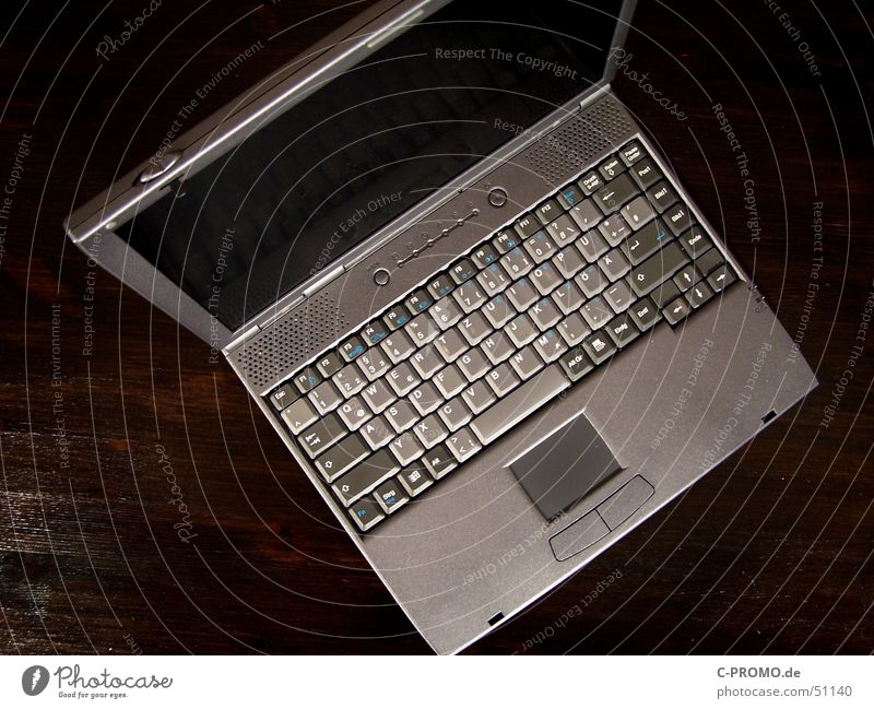 Grey laptop Touchpad Screen Flat Mobility Gray Brown Table Bird's-eye view Expensive Interior shot Electrical equipment Technology Media Keyboard Business