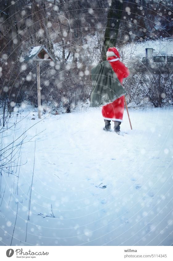Santa Claus trudging through snowy winter forest Sack Snow Christmas gifts bird house make a present to Santa Claus costume Wishes Anticipation snowflakes