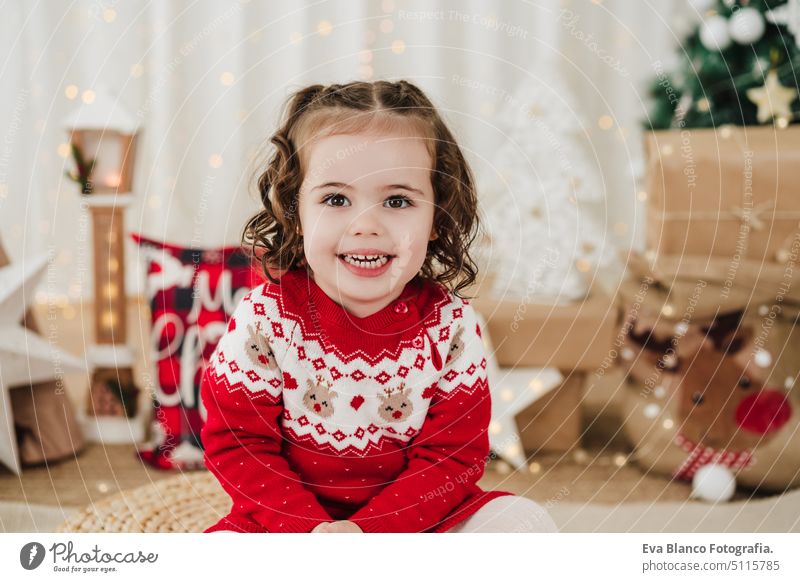 smiling cute little girl at home during christmas time child presents happy gift cheerful 2 kid children family december decoration indoors smile adorable star
