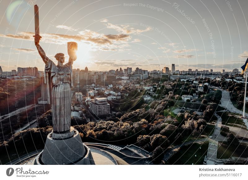 Kyiv, Ukraine - September, 2021: aerial view of Motherland Monument. Drone footage with sun flares. Monumental statue in the capital. One of the most important sights of city.