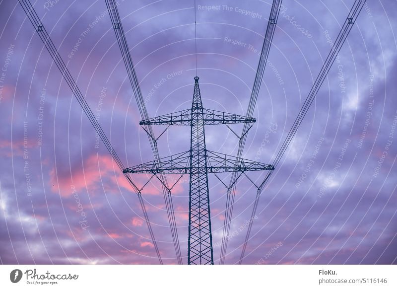 Power pole in front of purple clouds stream Energy Electricity pylon Clouds Power transmission Power consumption Cable high voltage High voltage power line