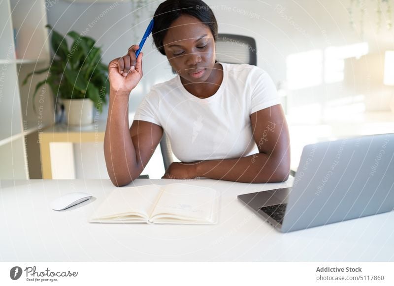 Thoughtful black student doing homework woman think assignment thoughtful education study scratch head female young african american ethnic laptop notebook