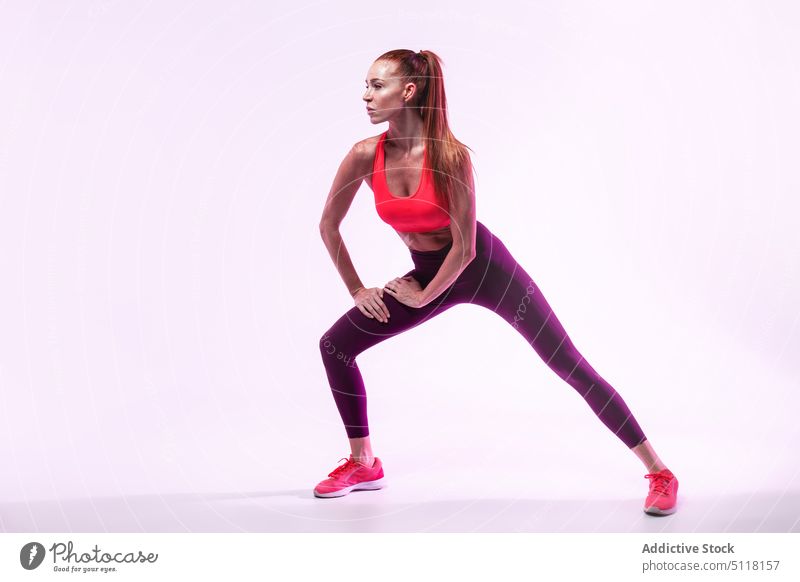 Sportswoman doing lunges during training sportswoman fitness exercise stretch sportswear wellness activity female adult practice power strength workout athlete