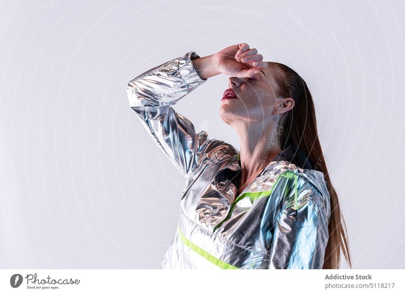 Stylish woman in holographic jacket model fashion style cover eyes makeup trendy posture vogue modern appearance cool personality outfit young feminine female