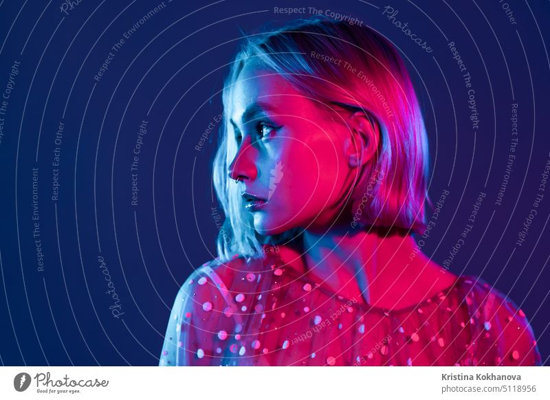 Mysterious hipster teenager. Portrait of millennial pretty girl with short hairstyle with neon light. Dyed blue and pink hair. glamour fashion woman beauty