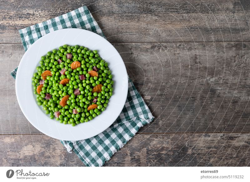 Green peas with serrano ham and carrot on wooden table appetizer bowl colorful cooked cuisine delicious diet dinner dish food fresh gourmet green healthy