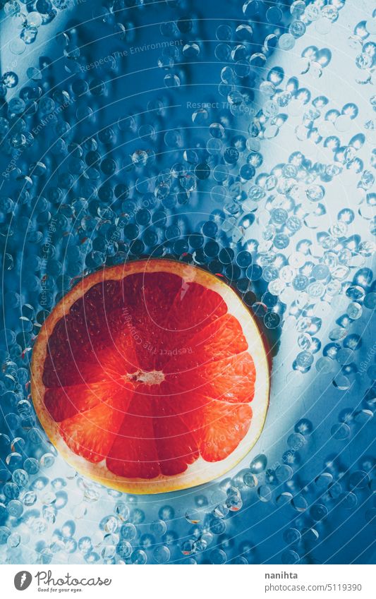Background image of a grapefruit slice against an elegant and fresh blue background simple diamond grapfruit pattern texture color intense citric summer