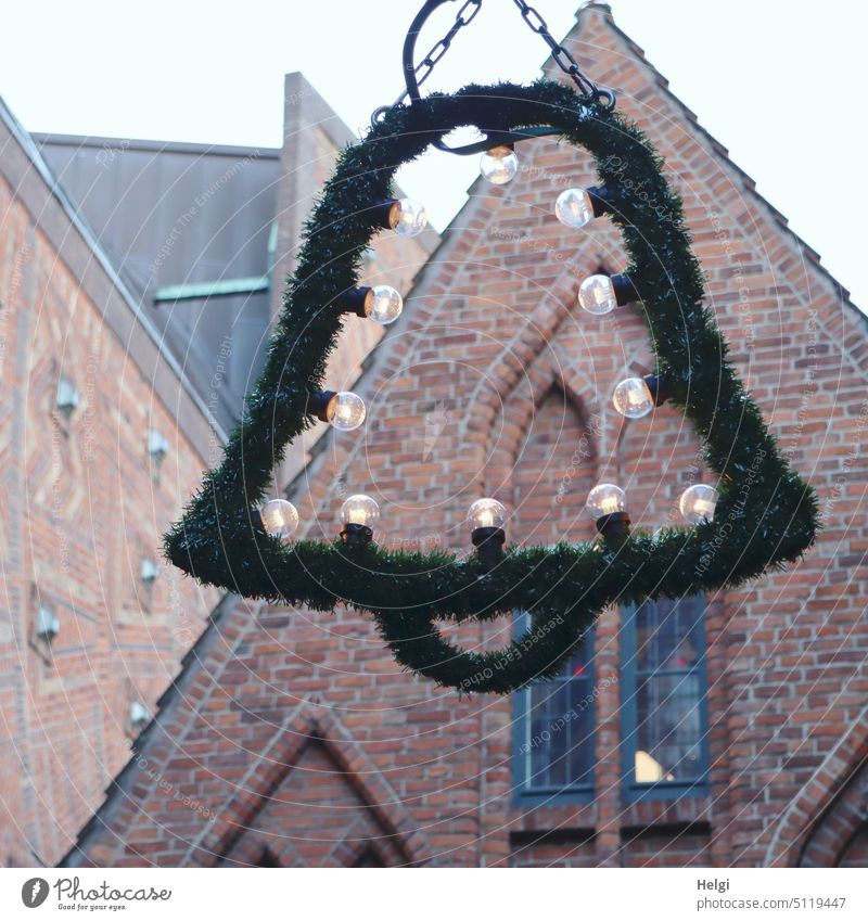 Christmas decoration in the form of a bell made of fir branches with light bulbs in front of old buildings Bell Christmas & Advent Lighting Old town Building